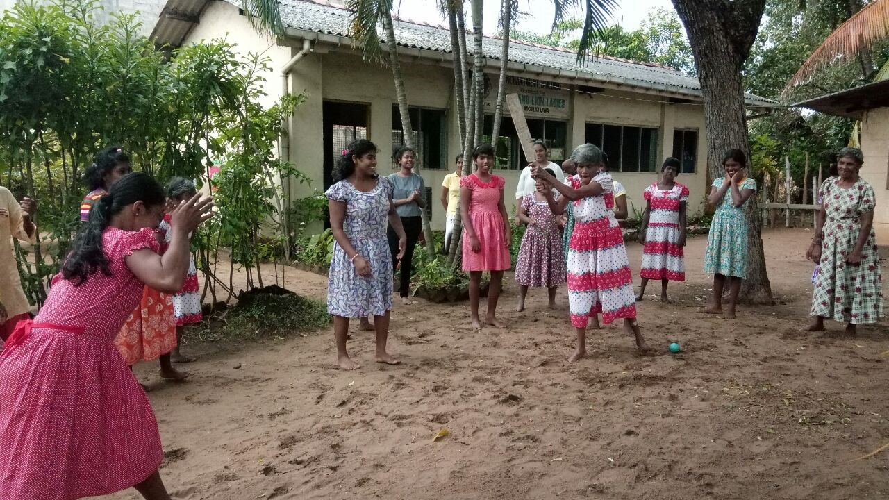 A lady from the home showing off her batting skills